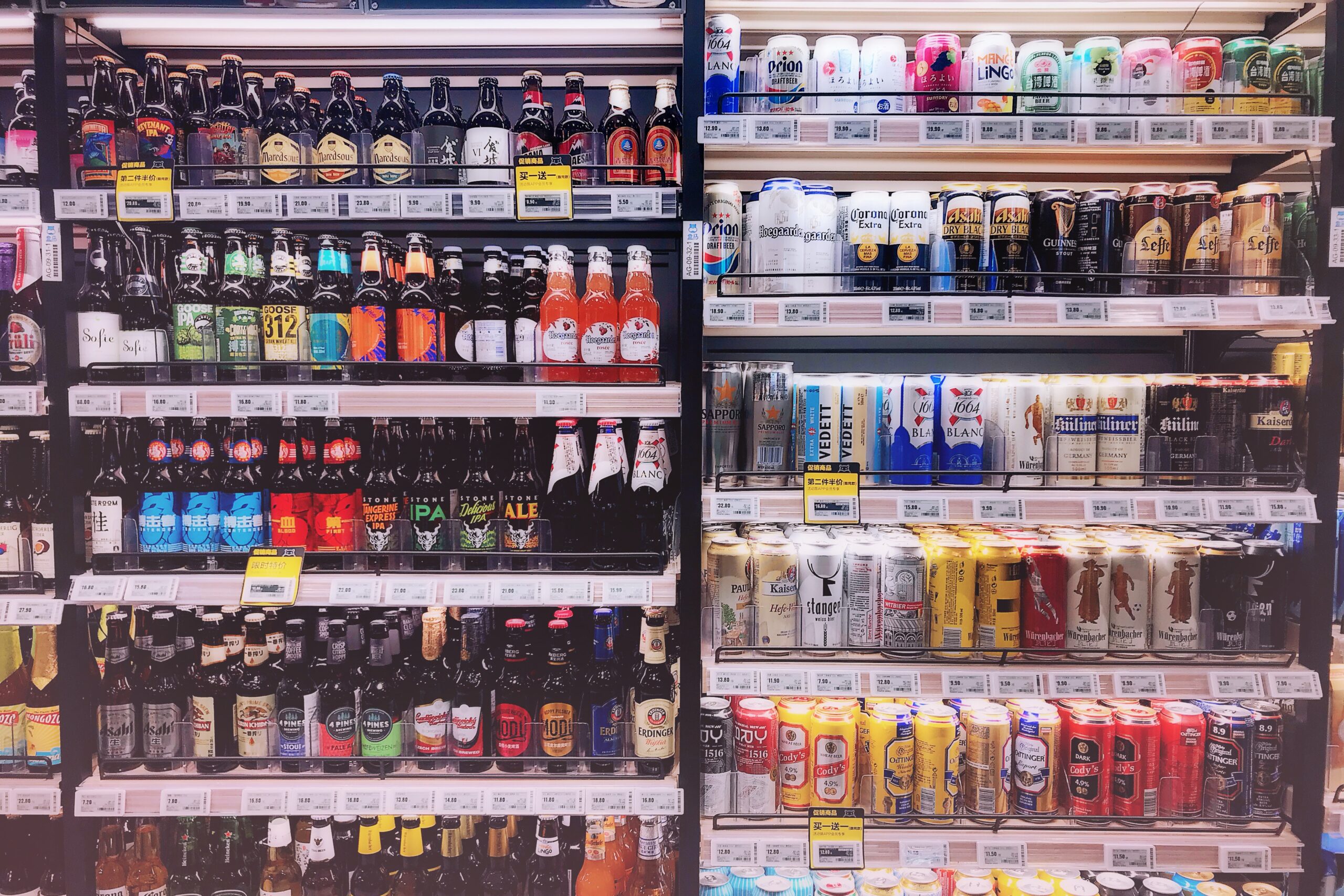 photo of convenience store shelves filled with bottles of drinks and features electronic shelf labels